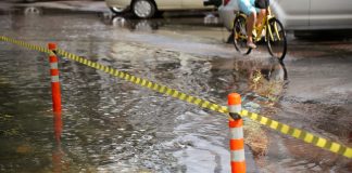 Passenger Steps In To Help Elderly Pedicab Driver Through Floodwaters