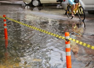 Passenger Steps In To Help Elderly Pedicab Driver Through Floodwaters
